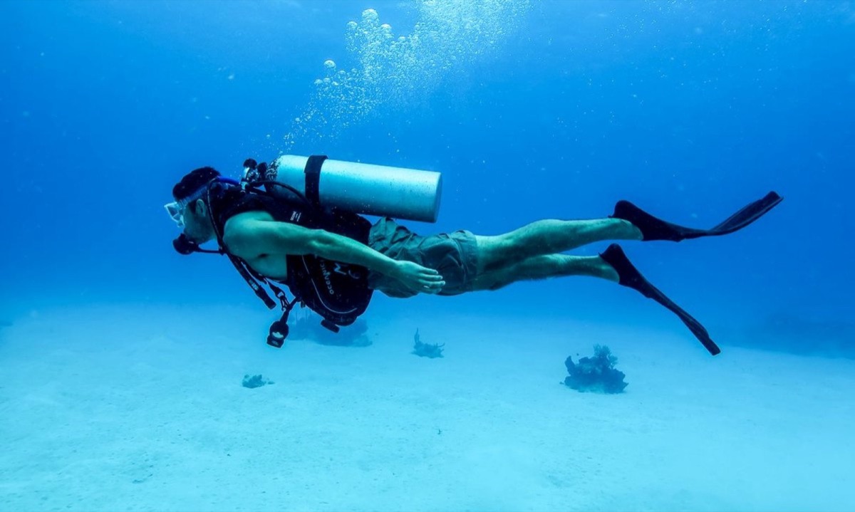 Scuba diver exploring coral reef