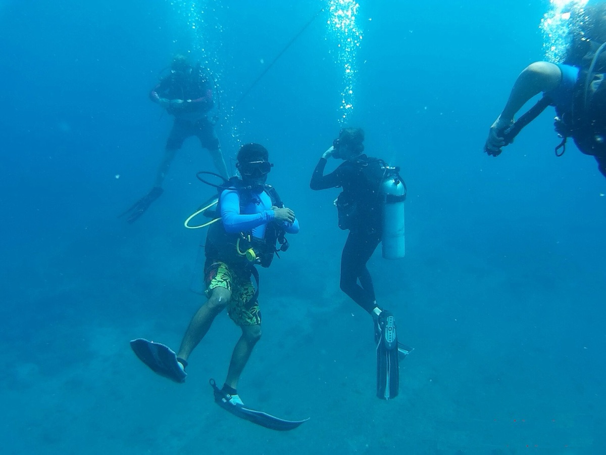 Scuba diver underwater with coral